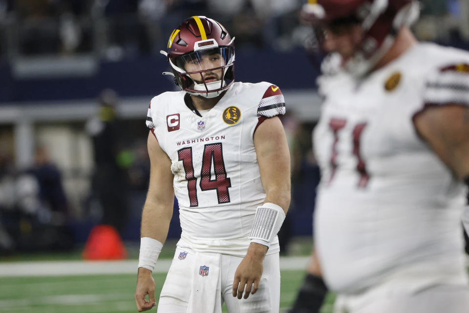 Washington Commanders quarterback Sam Howell (14) walks off the field after turning the ball over on downs during the second half of an NFL football game against the Dallas Cowboys Thursday, Nov. 23, 2023, in Arlington, Texas. (AP Photo/Michael Ainsworth)