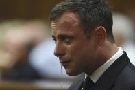 Olympic and Paralympic track star Oscar Pistorius reacts during judgement at the North Gauteng High Court in Pretoria, September 11, 2014. A South African judge cleared Oscar Pistorius of all murder charges on Thursday, saying prosecutors had failed to prove the Olympic and Paralympic track star intended to kill his girlfriend or an imagined intruder on Valentine's Day last year. REUTERS/Phill Magakoe/Pool (SOUTH AFRICA - Tags: SPORT ATHLETICS ENTERTAINMENT CRIME LAW SOCIETY TPX IMAGES OF THE DAY)