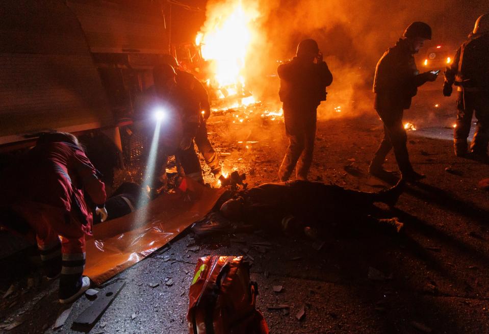 Emergency workers try to save people while fire rages (EPA)