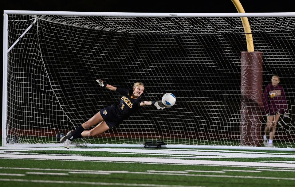 Harrisburg Tigers' goalkeeper, Stella Litzen (1), makes a diving save in the Class AA semifinal game against Sioux Falls Roosevelt on Tuesday night in Harrisburg. Litzen had a shutout performance as the Tigers won 3-0.