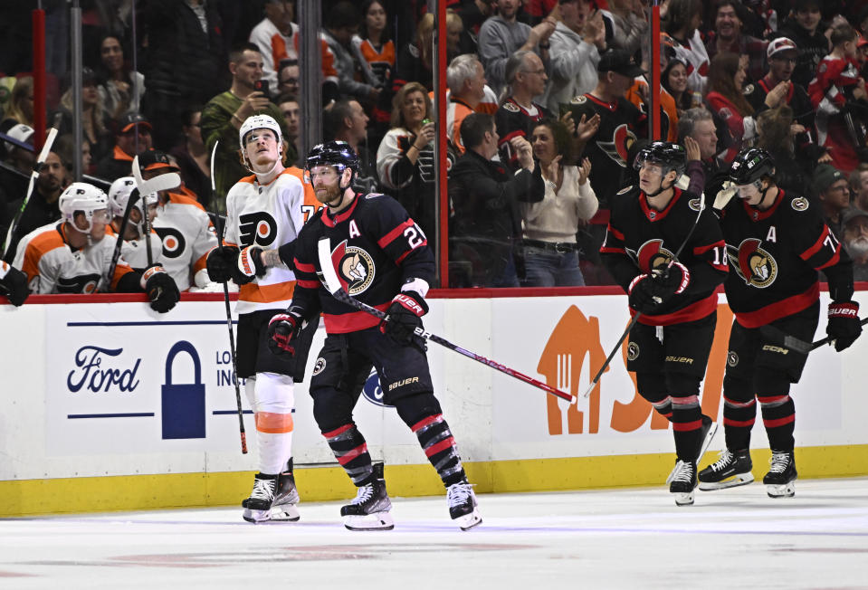 Ottawa Senators right wing Claude Giroux (28) passes Philadelphia Flyers right wing Owen Tippett (74) as he heads to the Senators bench to celebrate his goal during the first period of an NHL hockey game, Saturday, Nov. 5, 2022 in Ottawa, Ontario. (Justin Tang/The Canadian Press via AP)