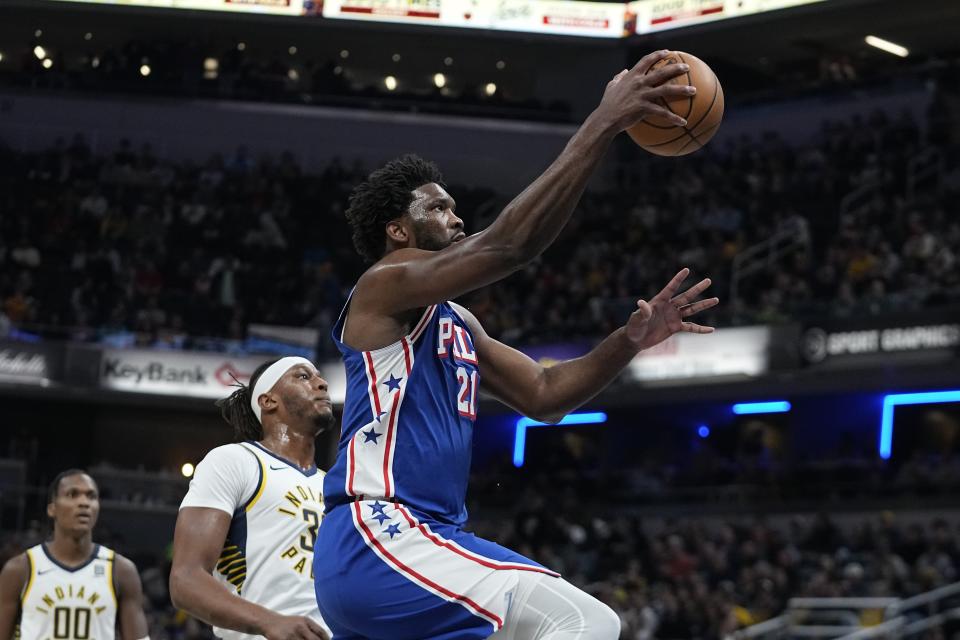 Philadelphia 76ers' Joel Embiid (21) shoots next to Indiana Pacers' Myles Turner (33) during the first half of an NBA basketball game Thursday, Jan. 25, 2024, in Indianapolis. (AP Photo/Darron Cummings)