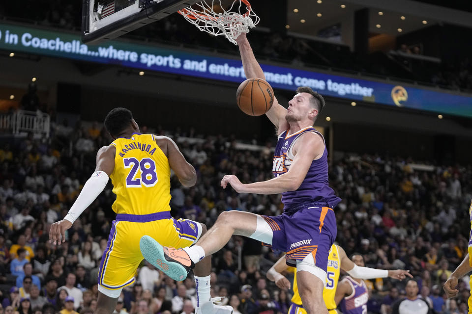 Phoenix Suns forward Drew Eubanks, right, dunks as Los Angeles Lakers forward Rui Hachimura defends during the second half of an NBA preseason basketball game Thursday, Oct. 19, 2023, in Thousand Palms, Calif. (AP Photo/Mark J. Terrill)