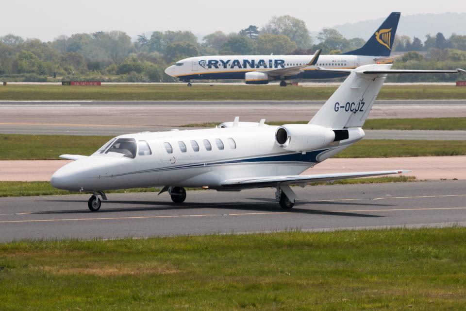 Centerline Cessna Citation CJ2 business jet (G-OCJZ) taxiing on Manchester International Airport tarmac.