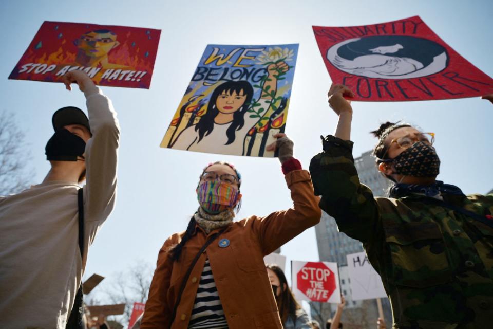 <p>Several protestors hold up signs during the Rally Against Hate in N.Y.C. on March 21, including ones that say, "Stop Asian Hate," "We Belong" and "Solidarity Forever."</p>