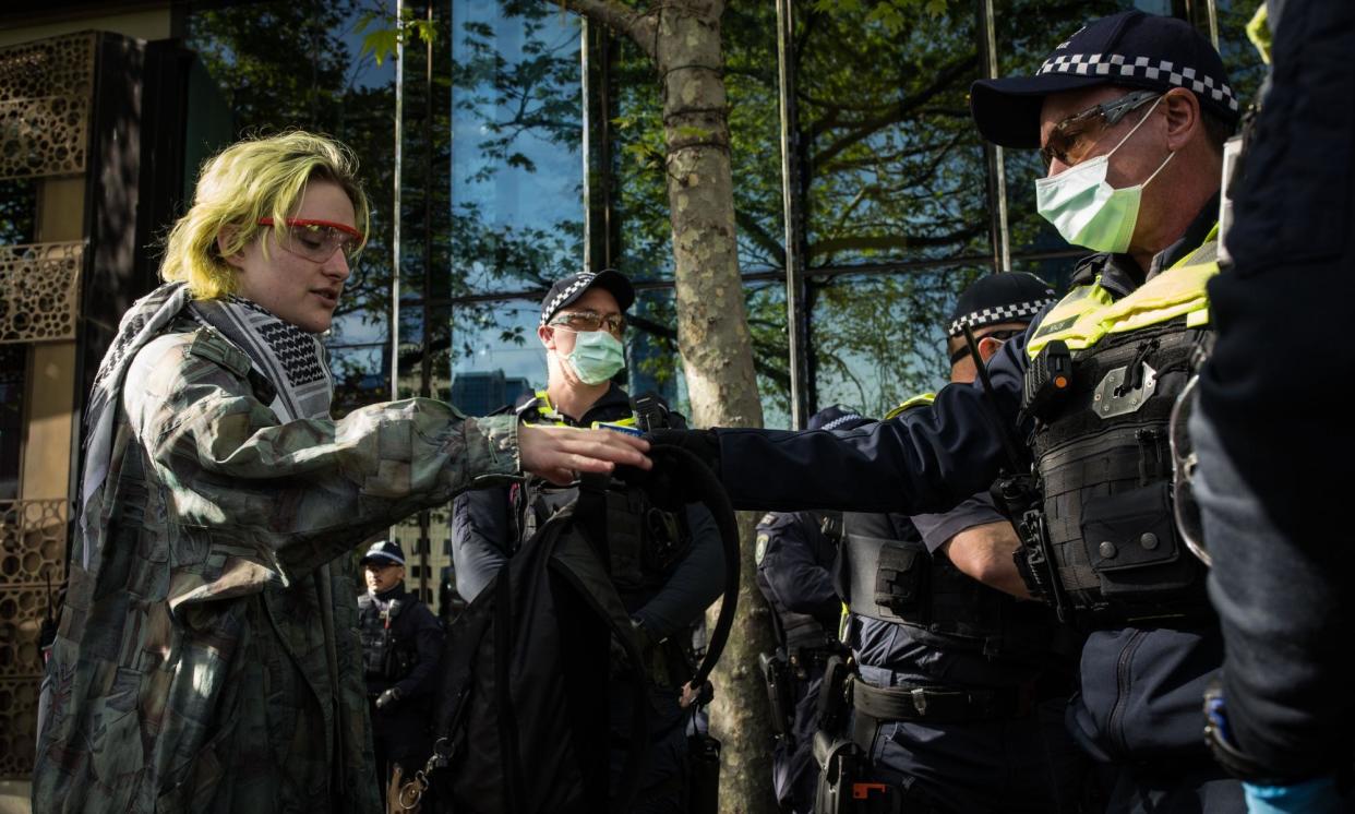 <span>Victoria police search the bag of a protester on Thursday as anti-war protesters in Melbourne’s CBD disrupt the Land Forces International Land Defence Exposition.</span><span>Photograph: Darrian Traynor/Getty Images</span>