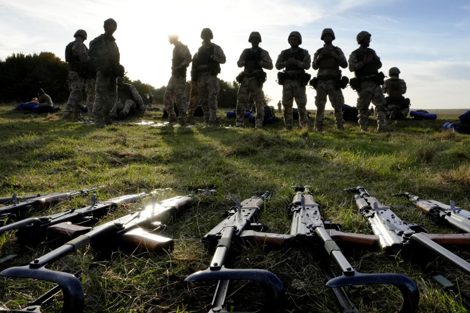 FILE - Weapons lie on the ground as Ukrainian personnel take a break during training at a military base with UK Armed Forces in Southern England on Oct. 12, 2022. The U.S. military's new, expanded combat training of Ukrainian forces began in Germany on Sunday, Jan. 15, 2023, with a goal of getting a battalion of about 500 troops back on the battlefield to fight the Russians in the next five to eight weeks, said Gen. Mark Milley, chairman of the Joint Chiefs of Staff. (AP Photo/Kirsty Wigglesworth, File)