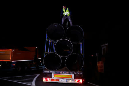 A worker removes steels tubes, which will be used to protect a deep well, next to the area where Julen, a Spanish two-year-old boy who fell into it, a 25-centimetre (9.8 inch) wide and around 100-metre (328 feet) deep well, four days ago when the family was taking a stroll through a private estate, in Totalan, southern Spain, January 17, 2019. REUTERS/Jon Nazca