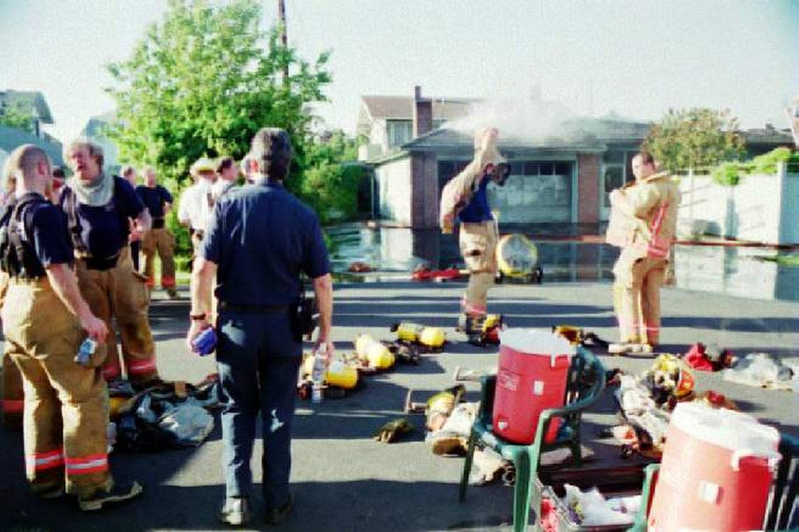 Neil Carlberg, second from left, is shown with other Bellingham firefighters at a fire in an undated file photo. It was estimated Carberg 900 to 1,200 fires in his 33-year career with Bellingham Fire.