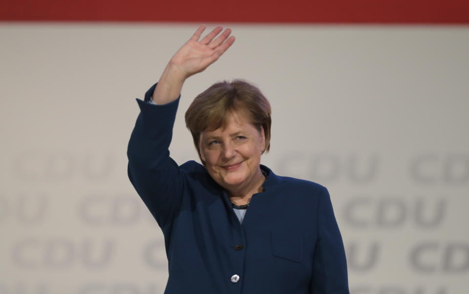 German Chancellor Angela Merkel waves after her speech at the party convention of the Christian Democratic Party CDU in Hamburg, Germany, Friday, Dec. 7, 2018. 1001 delegates are electing a successor of German Chancellor Angela Merkel who doesn't run again for party chairmanship after more than 18 years at the helm of the party. (AP Photo/Markus Schreiber)