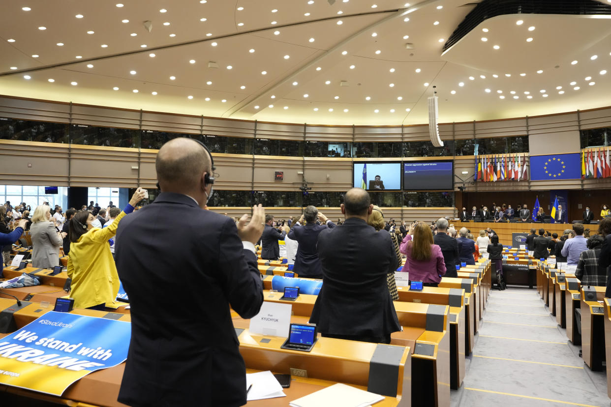 Members of the European Parliament stand and applaud.