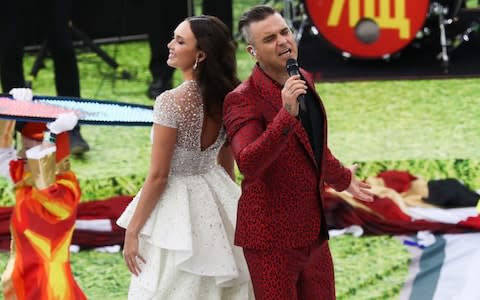 Russian soprano Aida Garifullina (L) and British singer Robbie Williams - Credit: TASS via Getty