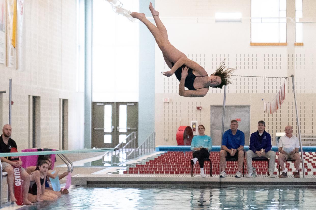 Hayden's Kaylee Gregg performs a back one somersault one-and-a-half twist maneuver during Wednesday's Topeka West Invitational meet at Capitol Federal Natatorium.