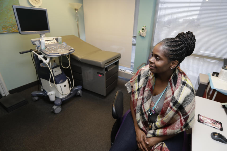 Medical assistant Allegra Pierce talks about the health services at Preterm, Tuesday, Feb. 25, 2020, in Cleveland. An ultrasound machine rests in the background. A federal court in Cincinnati will hear complex legal arguments for and against Ohio's Down syndrome abortion ban Wednesday, March 11, 2020 in a case viewed as pivotal in the national debate over the procedure. The Ohio law prohibits physicians from performing an abortion if they're aware that a diagnosis of Down syndrome, or the possibility, is influencing the decision. (AP Photo/Tony Dejak)