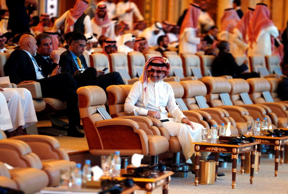 Saudi Arabian billionaire Prince Alwaleed bin Talal seated at a conference.