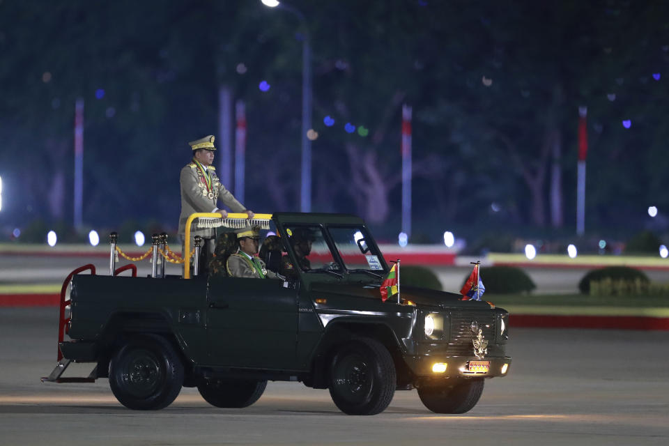 Senior Gen. Min Aung Hlaing, head of the military council, stands on a military truck as he inspects officers during a parade to commemorate Myanmar's 79th Armed Forces Day, in Naypyitaw, Myanmar, Wednesday, March 27, 2024. (AP Photo/Thein Zaw)