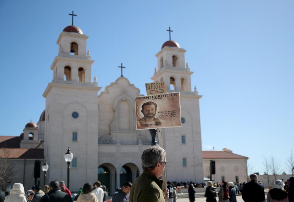 A man holds a banner bearing an image of Blessed Stanley Rother during the Blessed Stanley Rother Shrine dedication Mass in February 2023 in Oklahoma City.