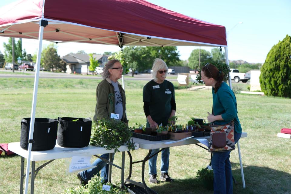 Gardeners speak about plants to a customer at the Randall County Master Gardeners plant sale Saturday as part of Gardenfest at the Texas A&M AgriLife Extension Center in Amarillo.