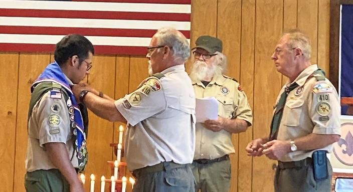Troop 410 leaders Larry Springer, Dan Becker and Keith Knisley present Chase Gray with his Eagle Scout neckerchief, badge and medal.