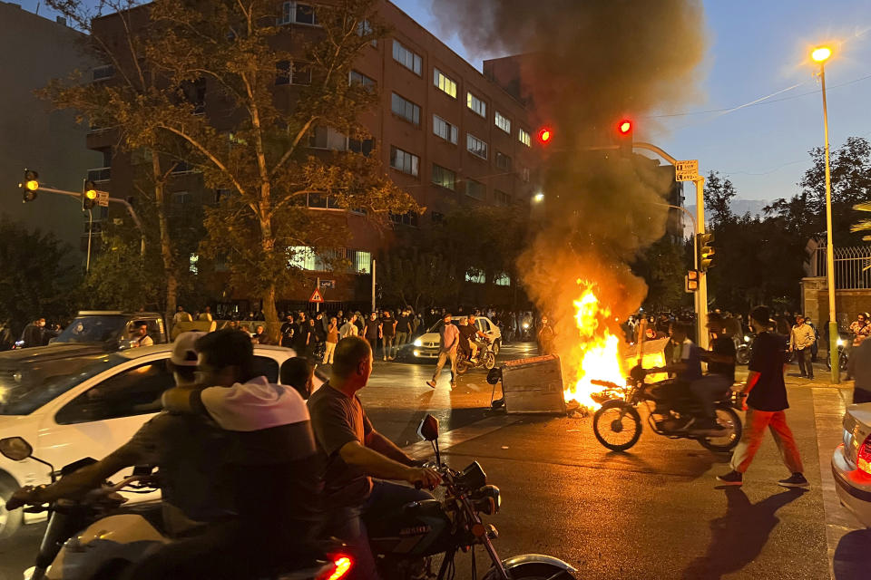 In this Monday, Sept. 19, 2022, photo taken by an individual not employed by the Associated Press and obtained by the AP outside Iran, a police motorcycle and a trash bin are burning during a protest over the death of Mahsa Amini, a 22-year-old woman who had been detained by the nation's morality police, in downtown Tehran, Iran. Spontaneous mass gatherings to persistent scattered demonstrations have unfolded elsewhere in Iran, as nationwide protests over the death of a young woman in the custody of the morality police enter their fourth week. (AP file)