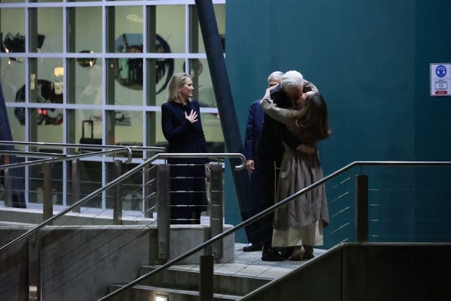 Julian Assange embraces his wife