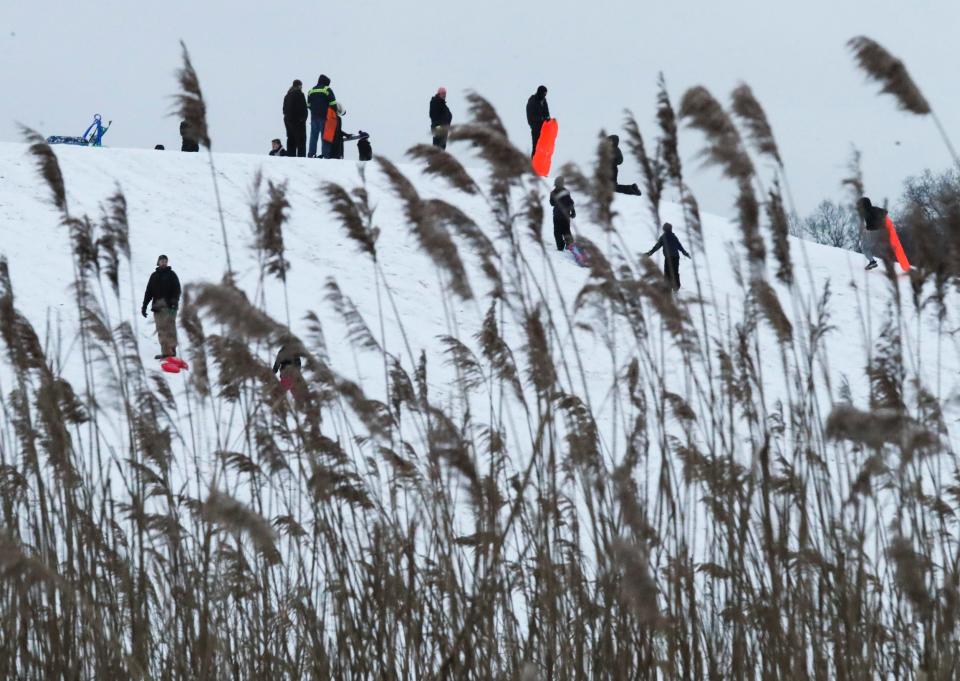 People take advantage of a snowstorm and the sledding hill at Glasgow Park, Feb. 18, 2021.