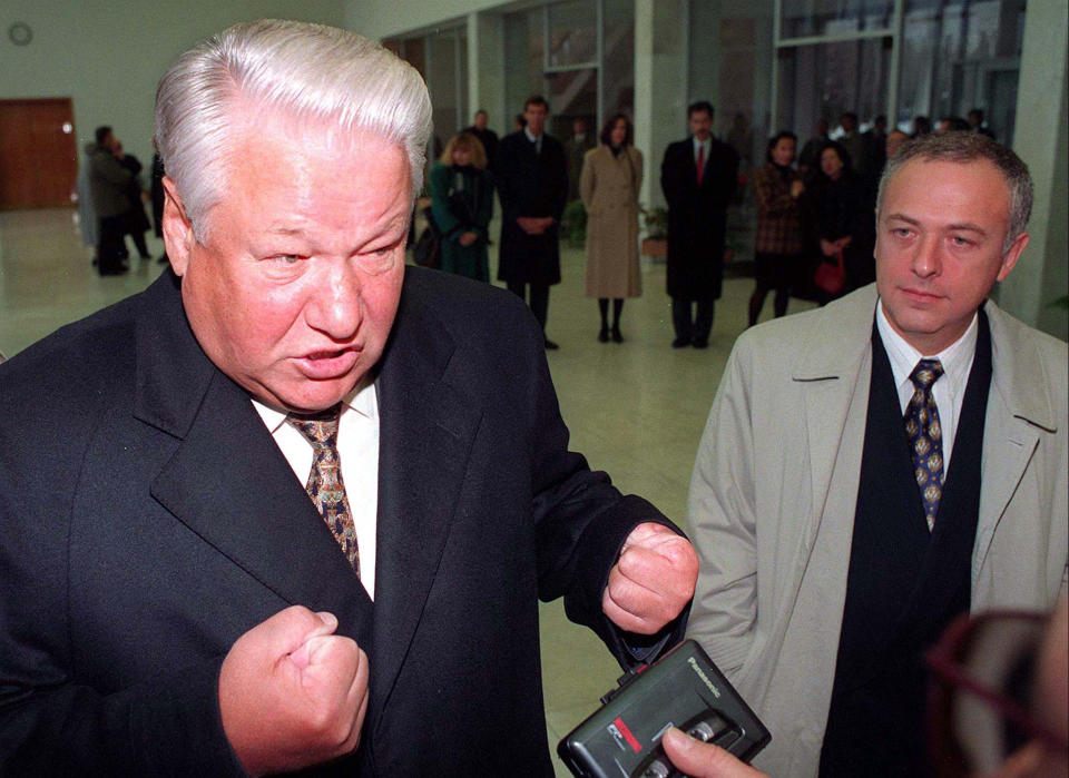 Russian President Boris Yeltsin (L) stands with Russian Foreign Minister Andrei Kozyrev as he talks with journalists at Vnukovo Airport, Moscow, October 20.  Speaking at the airport, before leaving for France and the United States, Yeltsin appeared to step back from  his threat to sack Kozyrev, saying that Kozyrev's performance would be improved if he found a good deputy to handle his paperwork