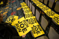 Workers lay out signs that read "Run Joe Run" ahead of a speech by former Vice President Joe Biden to the International Association of Firefighters at the Hyatt Regency on Capitol Hill in Washington, Tuesday, March 12, 2019. (AP Photo/Andrew Harnik)