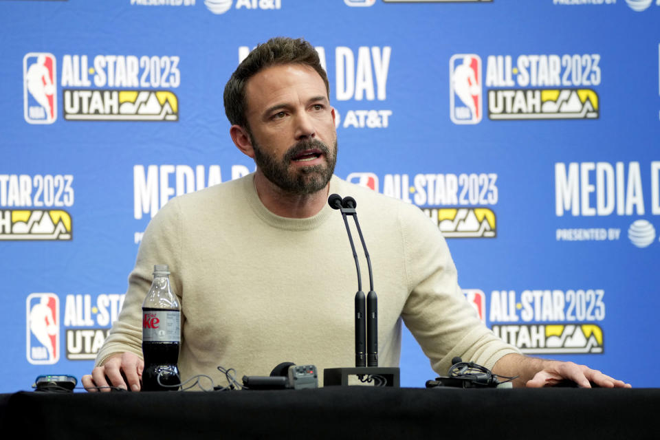 Closeup of Ben Affleck sitting in front of a microphone