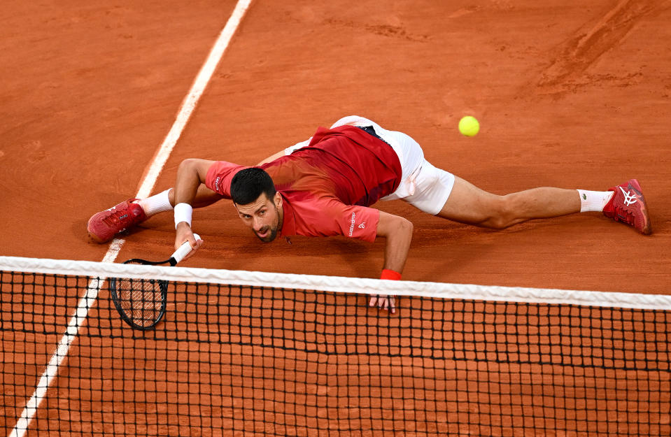 PARIS, FRANCE - JUNE 03: Novak Djokovic of Serbia falls after stretching for a forehand against Francisco Cerundolo of Argentina in the Men's Singles fourth round match during Day Nine of the 2024 French Open at Roland Garros on June 03, 2024 in Paris, France. (Photo by Clive Mason/Getty Images)