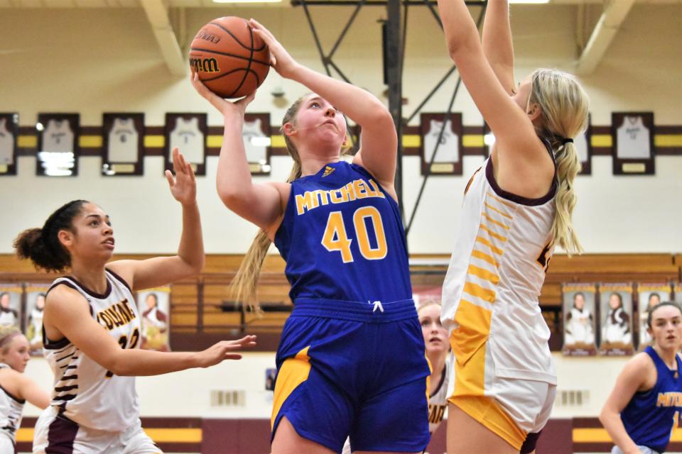 Maddie Robertson puts up a shot over Bloomington North's Mia Robbenolt.