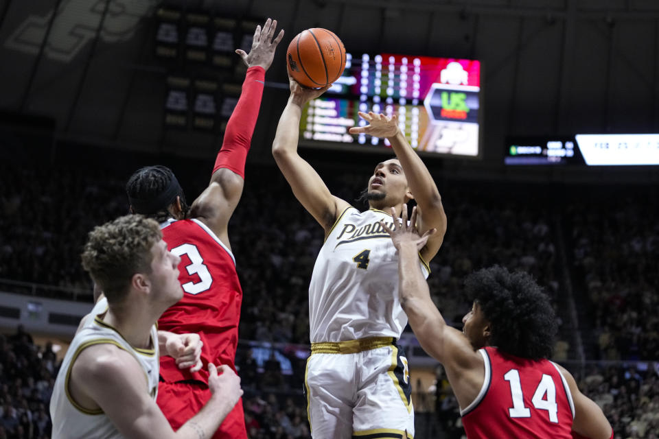 Purdue forward Trey Kaufman-Renn (4) shoots over Ohio State guard Eugene Brown III (3) in the second half of an NCAA college basketball game in West Lafayette, Ind., Sunday, Feb. 19, 2023. Purdue defeated Ohio State 82-55. (AP Photo/Michael Conroy)