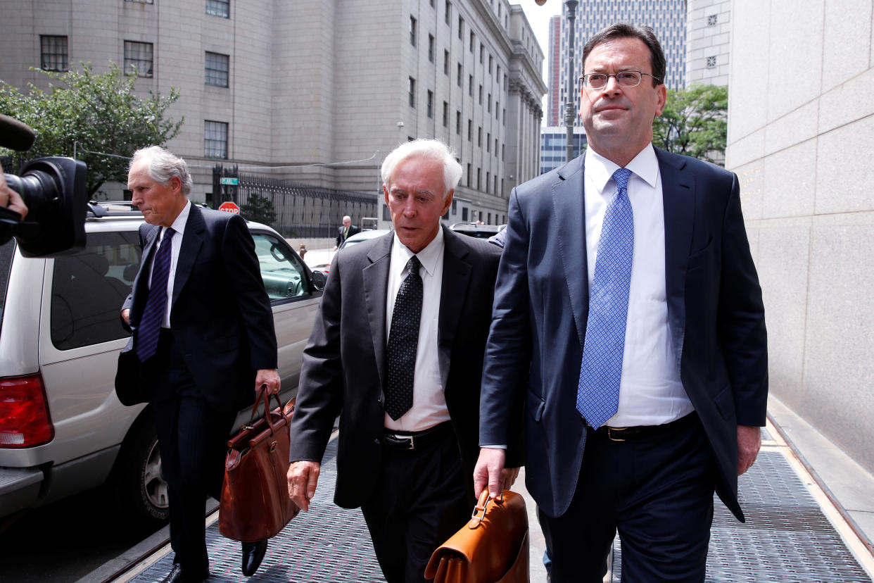 Billy Walters, center, seen here in 2016, has had his insider-trading conviction commuted by President Trump. (Reuters)
