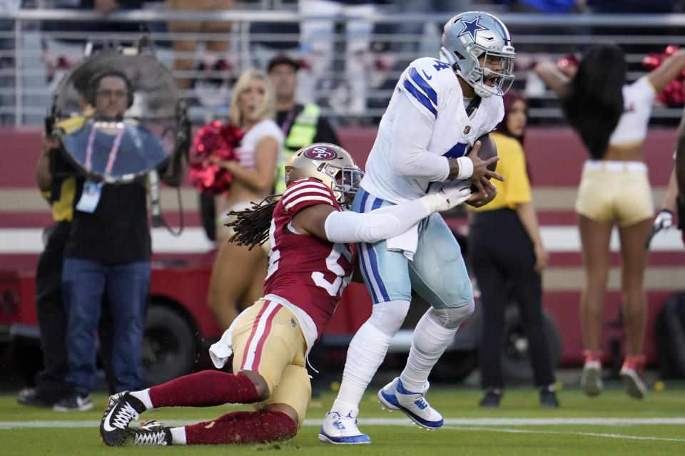 San Francisco 49ers linebacker Fred Warner, left, sacks Dallas Cowboys quarterback Dak Prescott during the first half of an NFL football game in Santa Clara, Calif., Sunday, Oct. 8, 2023. | Godofredo A. Vásquez, Associated Press