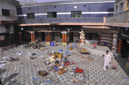 A member of the Hindu community walks inside a temple that was attacked on Saturday night, in Larkana, southern Pakistan's Sindh province, March 16, 2014. REUTERS/Faheem Soormro