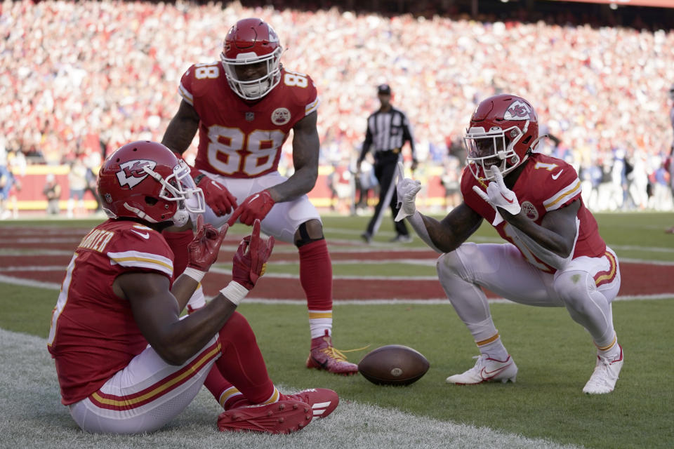Kansas City Chiefs wide receiver JuJu Smith-Schuster is congratulated by teammates Jody Fortson (88) and Jerick McKinnon (1) after scoring during the first half of an NFL football game against the Buffalo Bills Sunday, Oct. 16, 2022, in Kansas City, Mo. (AP Photo/Ed Zurga)
