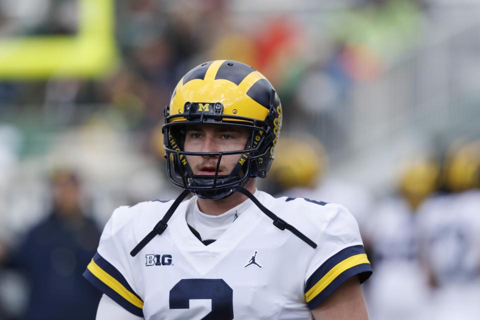 Michigan quarterback Shea Patterson is seen during warmups before the first half of an NCAA college football game against Michigan State , Saturday, Oct. 20, 2018, in East Lansing, Mich. (AP Photo/Carlos Osorio)