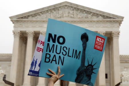 Protesters rally outside the U.S. Supreme Court, while the court justices consider case regarding presidential powers as it weighs the legality of President Donald Trump's latest travel ban targeting people from Muslim-majority countries, in Washington, DC, U.S., April 25, 2018. REUTERS/Yuri Gripas/Files