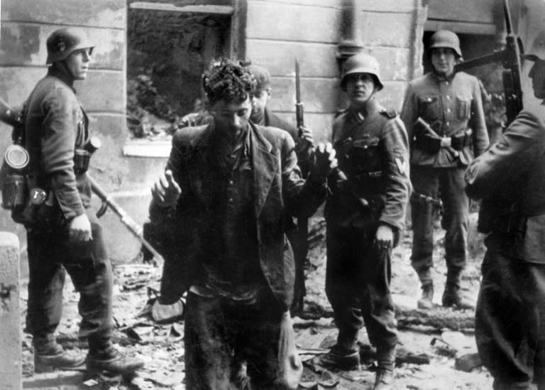 A Jew is arrested by German soldiers in April 1943 after the uprising of the Warsaw ghetto during World War II