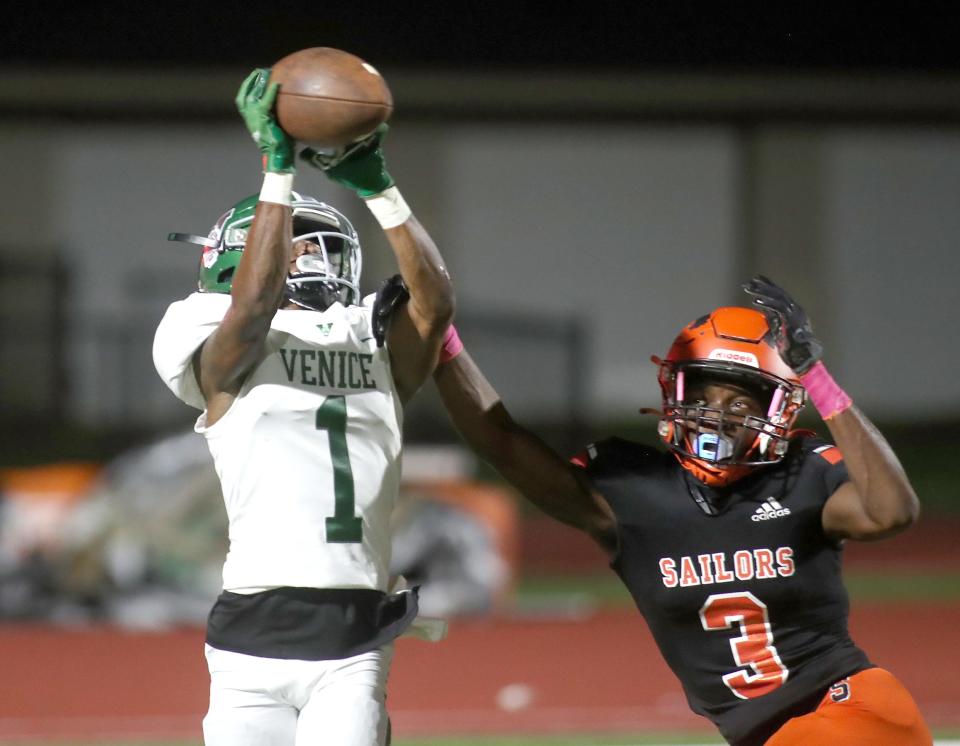 Venice wide receiver Keyon Sears (1) catches the ball for a gain against SarasotaÕs Caleb Bradley (3) during Friday night football action in Sarasota, Fl. Venice won the matchup 46-7. MATT HOUSTON/HERALD-TRIBUNE