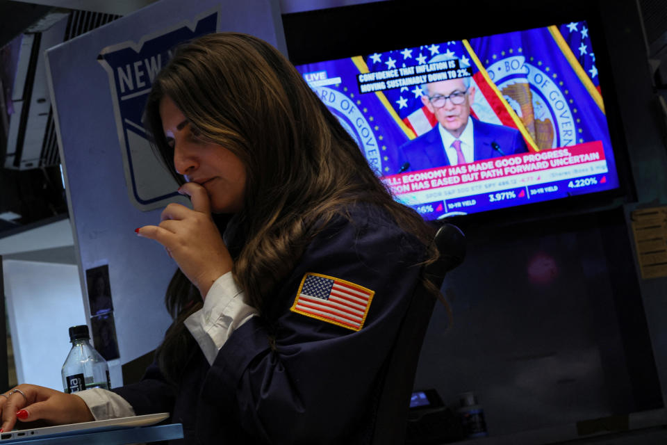 FTSE A trader works, as a screen displays a news conference by Federal Reserve Board Chairman Jerome Powell following the Fed rate announcement, on the floor of the New York Stock Exchange (NYSE) in New York City, U.S., January 31, 2024.  REUTERS/Brendan McDermid