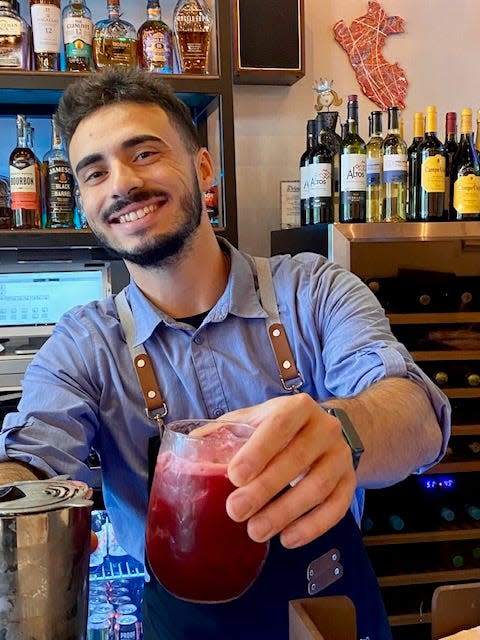 Bartender Anthony concocts a repertoire of cocktails at Cafe de Martin’s El Bar.