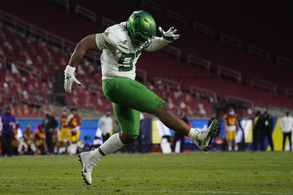 Oregon defensive tackle Brandon Dorlus (97) celebrates after a sack during the first quarter of an NCAA college football game for the Pac-12 Conference championship against Southern California, Friday, Dec 18, 2020, in Los Angeles. (AP Photo/Ashley Landis)