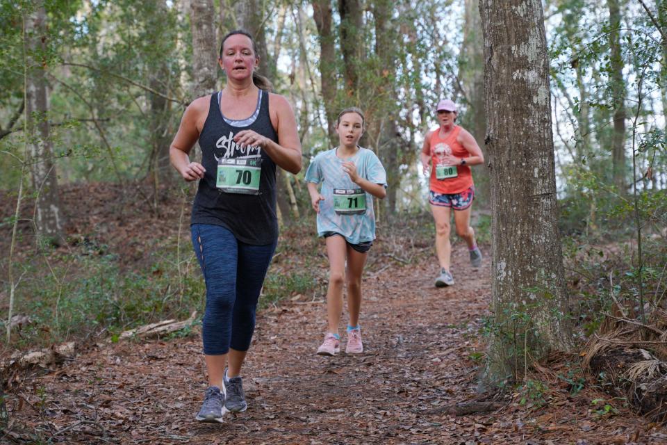 Participants run the course during the Carolina Beach State Park Trail Half Marathon and 5K in 2019.