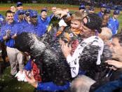 Oct 13, 2015; Chicago, IL, USA; Chicago Cubs starting pitcher Jon Lester (right) and son dump champagne on the head of catcher David Ross after defeating the St. Louis Cardinals in game four of the NLDS at Wrigley Field. Mandatory Credit: Jerry Lai-USA TODAY Sports