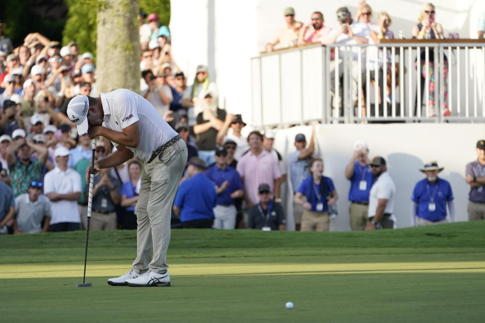 Lucas Glover reacts after missing a putt for birdie on the 18th green during the final round of the St. Jude Championship golf tournament Sunday, Aug. 13, 2023, in Memphis, Tenn. (AP Photo/George Walker IV)