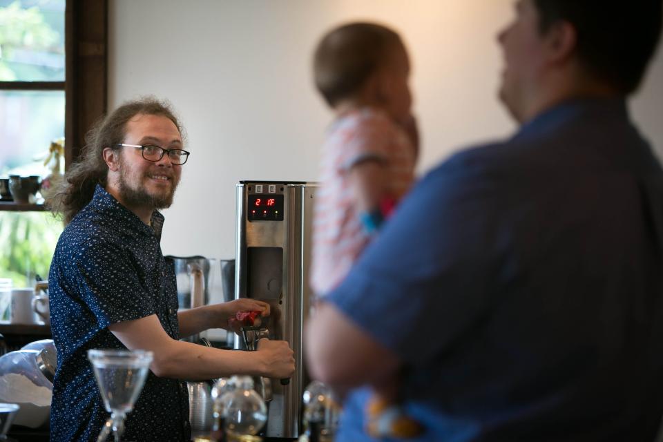 Todd Purse serves customers at the 2016 opening of Brew HaHa! in Greenville.