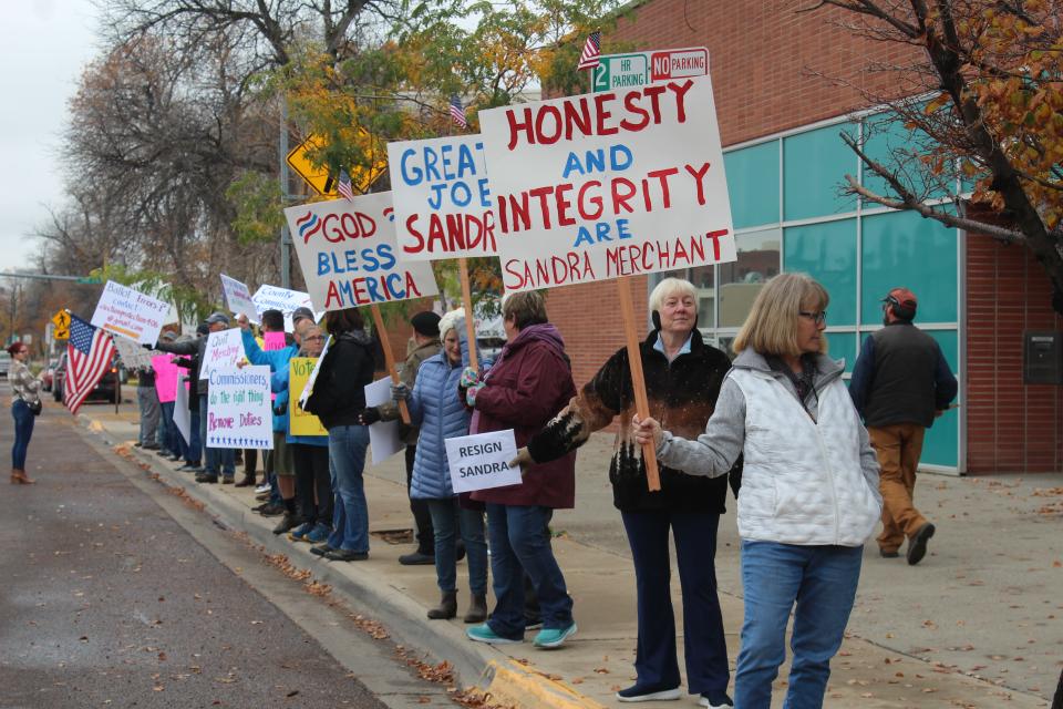 Supporters of Cascade County Clerk and Recorder Sandra Merchant rally outside the elections office on Monday