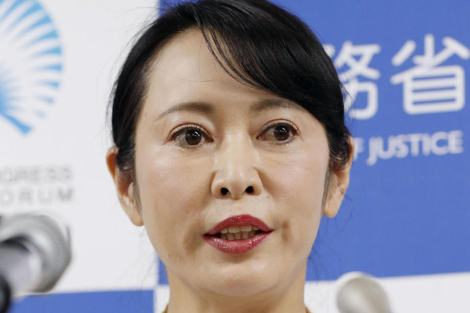 Japanese Justice Minister Masako Mori speaks to reporters following Nissan's former Chairman Carlos Ghosn's press conference in Beirut, at her ministry in Tokyo early Thursday, Jan. 9, 2020. Mori is denouncing Ghosn's criticism of the nation's criminal justice system. Mori said she wanted to prevent his spreading an "erroneous" understanding abroad about Japan's system. Ghosn, who skipped bail while awaiting trial here, said in Beirut that Japan's system was unfair and rigged. (Naoya Osato/Kyodo News via AP)