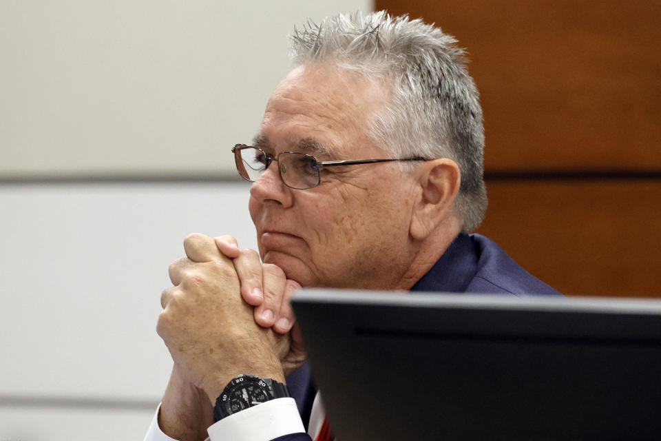 Former Marjory Stoneman Douglas High School School Resource Officer Scot Peterson, seated at the defense table, shakes his head as Sunrise Police Lt. Craig Cardinale (not shown) testifies during Peterson's trial at the Broward County Courthouse in Fort Lauderdale, Fla., on Tuesday, June 20, 2023. Broward County prosecutors charged Peterson, a former Broward Sheriff's Office deputy, with criminal charges for failing to enter the 1200 Building at the school and confront the shooter. (Amy Beth Bennett/South Florida Sun-Sentinel via AP, Pool)
